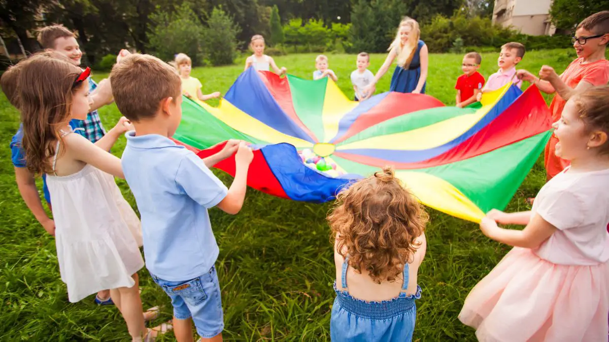 kids playing with parachute outside