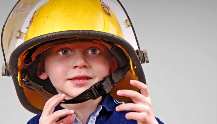 toddler wearing fireman helmet