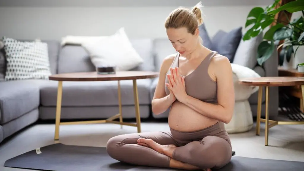 pregnant woman cracking back yoga